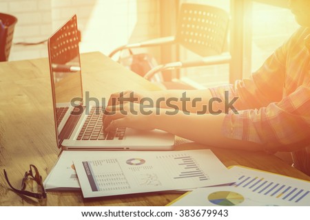 business man use  on-line via laptop computer for analyzing financial chart,writing business plan,open net-book,phone,tablets,with copy space screen,morning light,vintage color