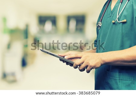 Male doctor,medical students or surgeon using digital tablet and laptop during the conference,Health Check with digital system support for patient,test results and patient registration,vintage color