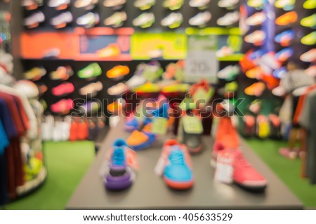 De focused/blurry background of Sports clothing store in Inter Sport store,Blur of city shopping people crowd at marketplace shoe shop abstract background,for use as a background,vintage color