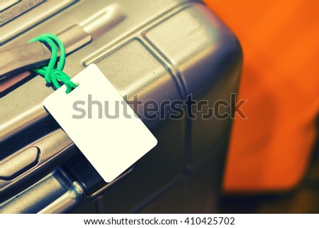 Close up of blank luggage tag on suitcase,luggage label,tag on luggage,Suitcase with TRAVEL INSURANCE label,selective focus,vintage color