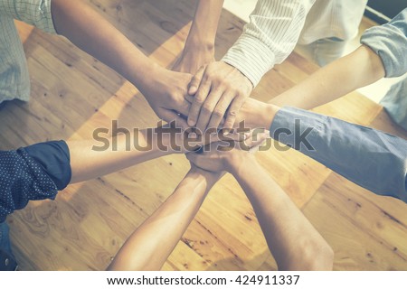 Teamwork,Business team standing hands together in the office.Business people joining hands together.People Teamwork hands together,teamwork online.business teamwork,join hands together,vintage color