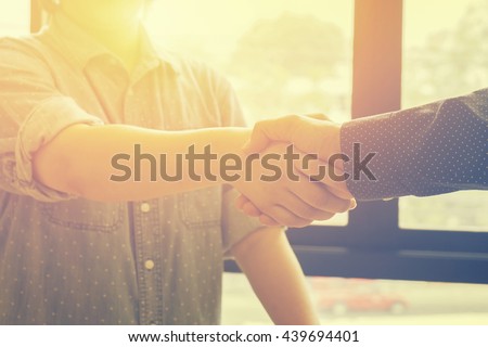 Great job,Sealing a deal,Successful business,Handshake,Business man holding hands,Good deal.two business people shaking hands standing at the working place,selective focus,Vintage tone,copy space