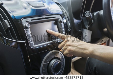 Transportation,technology and vehicle concept - man using car system control pushing panel button screen interface modern design