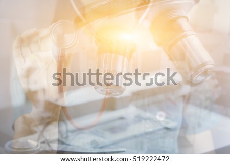 Double exposure of chemistry microscope, biology, medicine and people concept,doctor hand with Stethoscope making research in clinical laboratory,chemical liquid, science research,vintage color