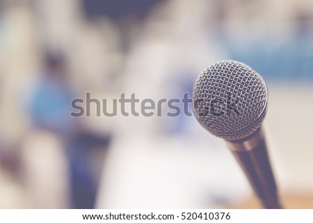 Close up of microphone in concert hall or conference room,conference hall or seminar room background,selective focus,vintage color,copy space