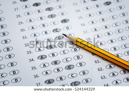 alarm clock, optical form of standardized test with answers bubbled and a black pencil examination,Answer sheet,education concept,selective focus,vintage