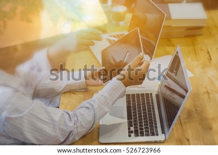 Teacher and student working on tablets and laptop computer,Businessman making presentation with his colleagues and business tablet digital computer at the office as concept,selective focus,vintage
