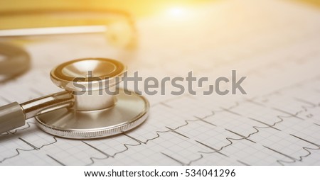 doctor workplace with a stethoscope Cardiogram chart with medical table closeup,for Surgeon heart record,selective focus,vintage color.for banner
