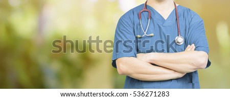 surgeon posing with arms crossed  with stethoscope in an operating theatre,surgical room,success smart medical doctor,healthcare and medical ,Green natural background  banner