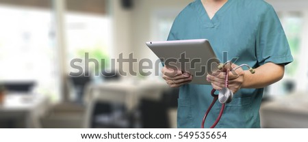 Male doctor,medical students or surgeon using tablet and laptop during the conference,Health Check with digital system support for patient,test results and data registration,selective focus