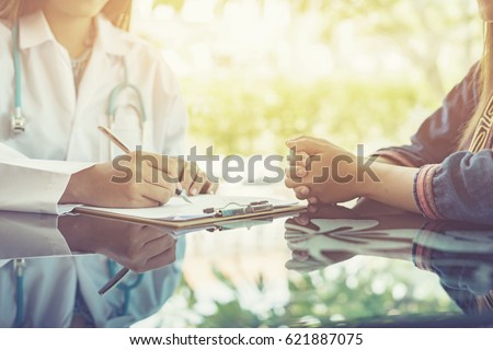 Women Doctors and patient are discussing something ,Having Consultation,Medical Pretty Doctor working in hospital writing a prescription, Healthcare and medically concept,selective focus
