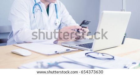 Male doctor,medical students or surgeon using cell smart phone tablet and laptop during the conference,Health Check with digital system support for patient,test results and data registration,Blue tone