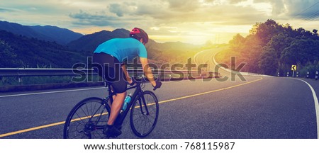 Cycling competition,cyclist athletes riding a race at high speed on mountain road, Sportsmen bikes in the morning,vintage color,selective focus, sports concept,low angle view,Business competition