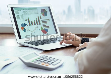 Accounting report spreadsheet. Business women using computer prepare business report for evaluation performance.