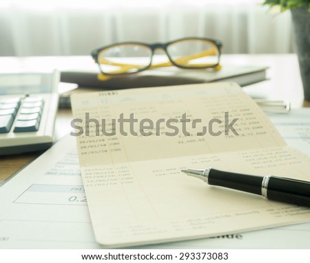 Accountants desk with pen and bank book. selective focus.