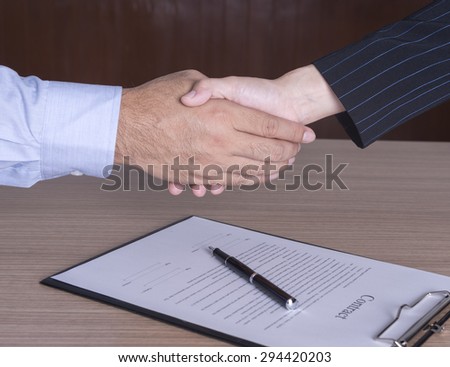 businessman and businesswoman shaking hands to congratulate to be working well.