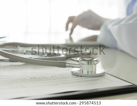 Close-up of stethoscope and medical Documentation on  background doctor working