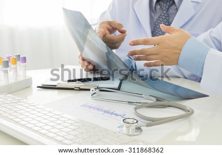 2 doctors working in office of hospital.