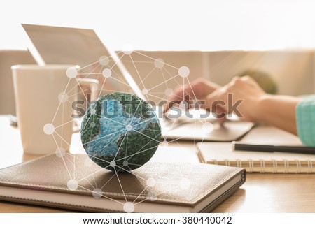 mock up the globe with digital social media network on notebook at office background.