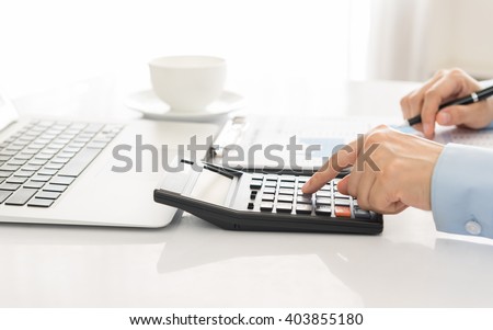 Businessman using a calculator to calculate the numbers. Accounting , Accountancy, Calculation Concept.