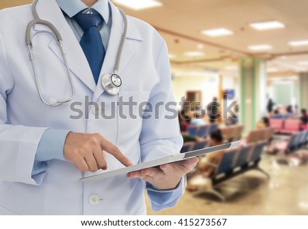 Doctor using a digital tablet computer in hospital. Healthcare And Medicine Concept.