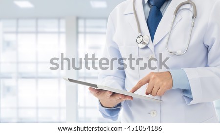Doctor or medical students using digital tablet find information patient medical history at the hospital. Medical technology concept.