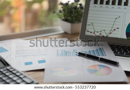 financial concept. business earning report and financial chart and graph report on desk.