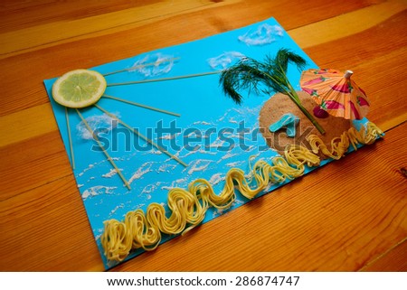Application of food in the form of islands in the sea and sun on a blue cloth on the kitchen table (soft focus)