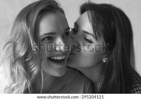 Girls girlfriend posing and laughing in a studio near the clock