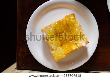 Bread, jam, pineapple in cafe room