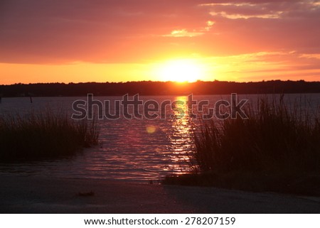 Sunset on the Bay.  The sun dips low as it\'s light reflects off the waters of the Chesapeake Bay.