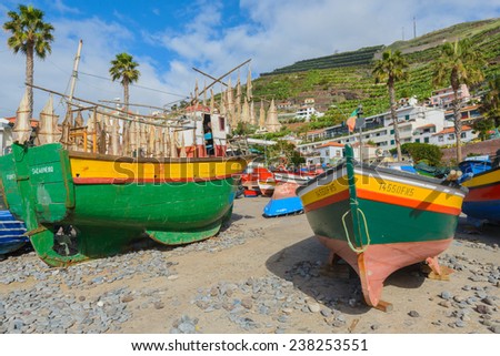 CAMARA DE LOBOS, MADEIRA ISLAND - NOV 12:  Fishing boats on the shore of Camara de Lobos village on 12 November 2014 in Madeira island. This fishing village is a popular tourist destination.