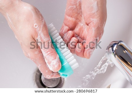 hygiene and health care. closeup woman washing her hands with brush