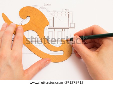 Woman performs technical drawing with pencil on white background