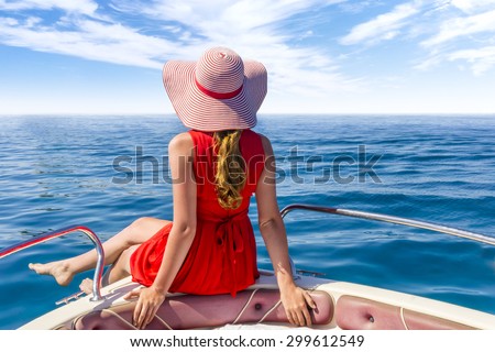 Girl in red dress on the luxury boat