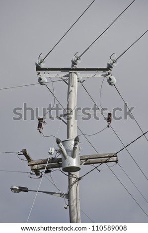 Electricity transmission through cables on wooden pole.