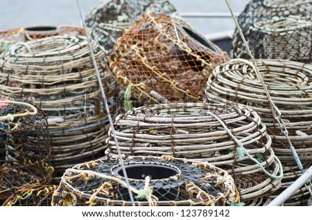 Lobster or crayfish pots stacked on fishing boat, close focus on centre pot, St Helens, Tasmania, Australia