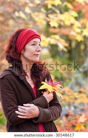 Contemplate the Autumn Attractive woman wearing headband surrounded by rich Autumn tones