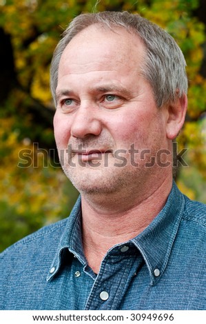 Handsome, mature working man with graying hair and stubble