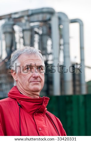 Factory man - man in red jacket near factory