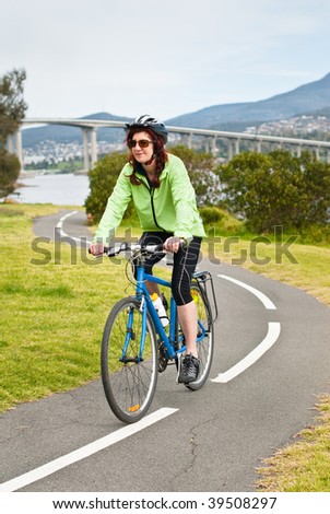 Female cyclist on s bend of cycle path