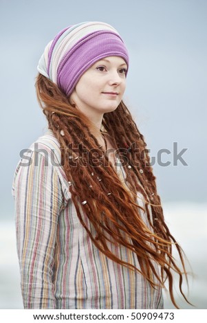 stock photo Beautiful young woman with dreadlocks hair decorations and 