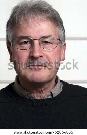 Bespectacled man in middle fifties wearing black sweater.