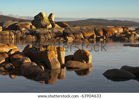 Orange lichen rocks and reflections, Bay of Fires, Tasmania
