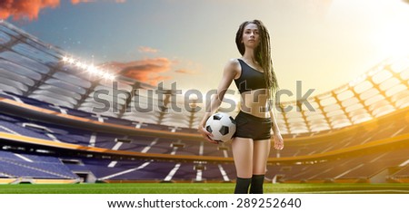 Young sexy woman player in soccer stadium