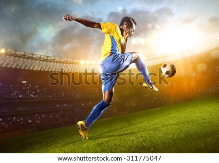 Afro-American soccer player in action. Stadium field