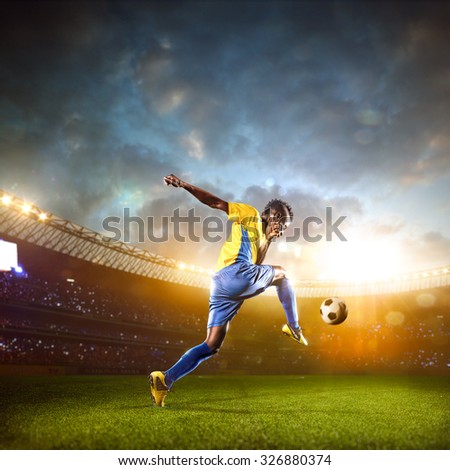 Black soccer player in action. Stadium field