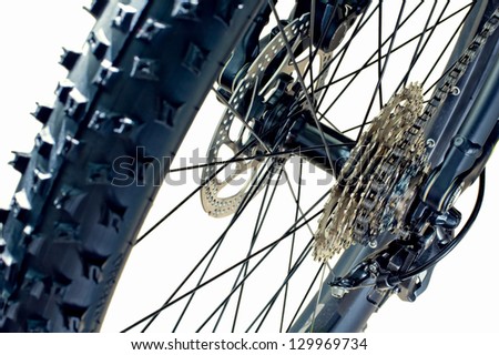 Detail of a rear tire, cassette, disc brake and rear derailleur of a brand new mountain bike
