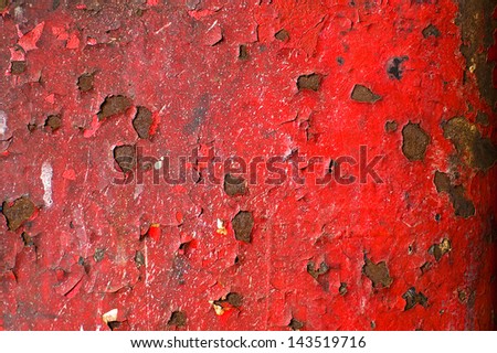 Red paint peeling off the wall