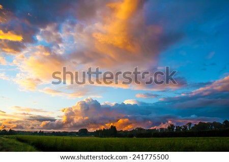 Romantic sunset sky with fluffy clouds.